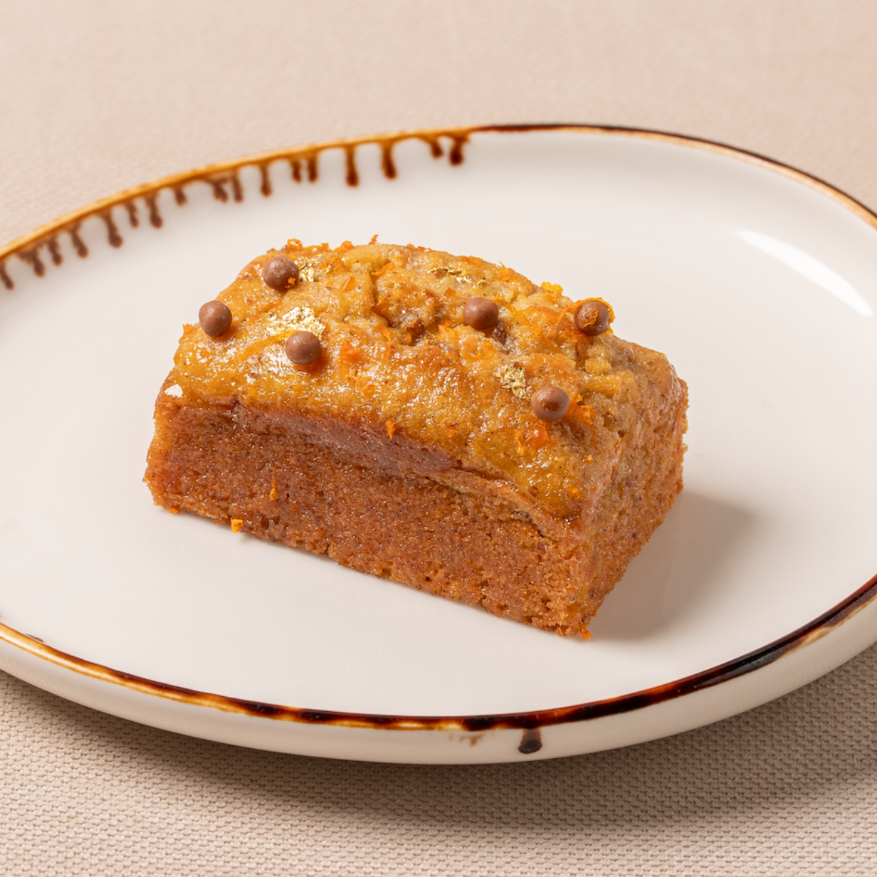 Slice of cake on a decorative plate with a beige background