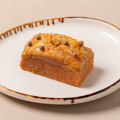 Slice of cake on a decorative plate with a beige background